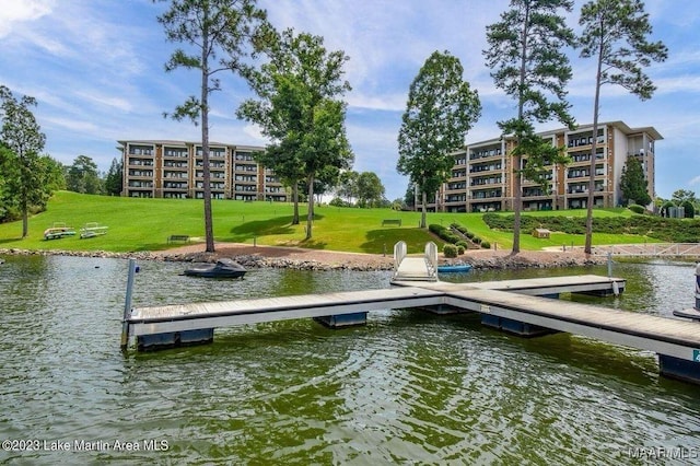 view of dock featuring a water view and a yard