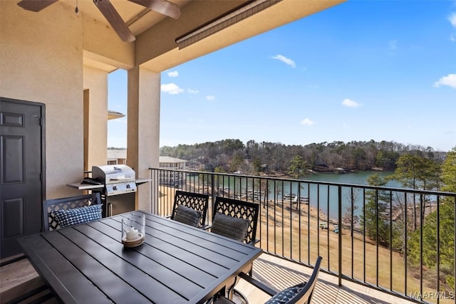 balcony with a water view, a grill, and ceiling fan