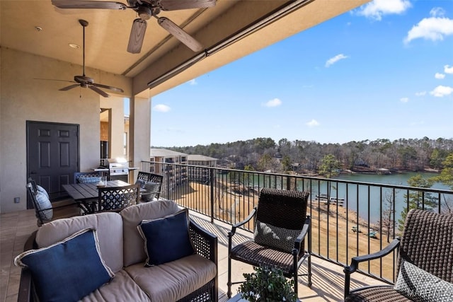 balcony with a water view, ceiling fan, and grilling area