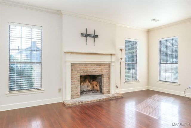 unfurnished living room featuring plenty of natural light, wood-type flooring, and crown molding