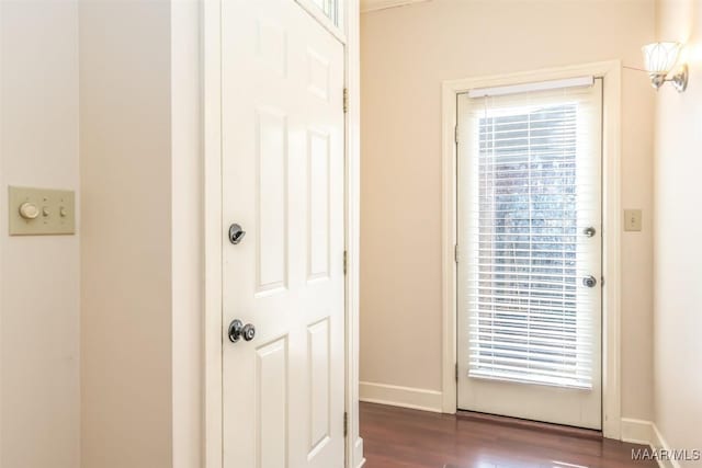 doorway to outside with dark wood-style flooring, plenty of natural light, and baseboards