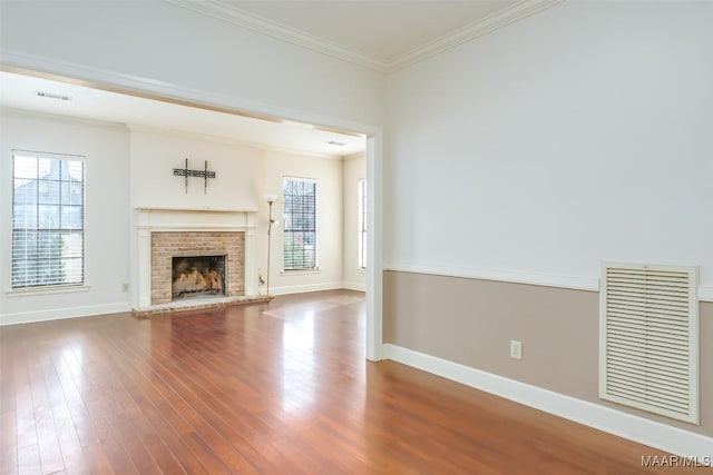 unfurnished living room with ornamental molding, dark wood-type flooring, visible vents, and baseboards