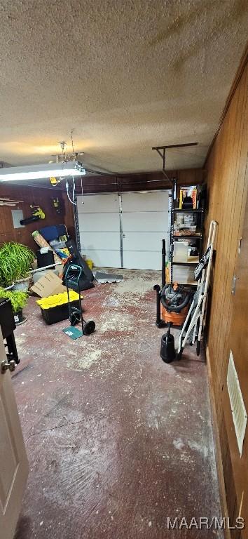 garage featuring wood walls