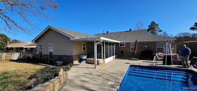 rear view of property featuring a patio area and a sunroom