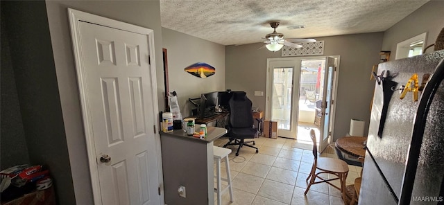 office with light tile patterned flooring, ceiling fan, and a textured ceiling