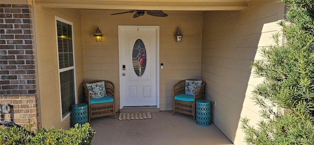 doorway to property with ceiling fan and a patio