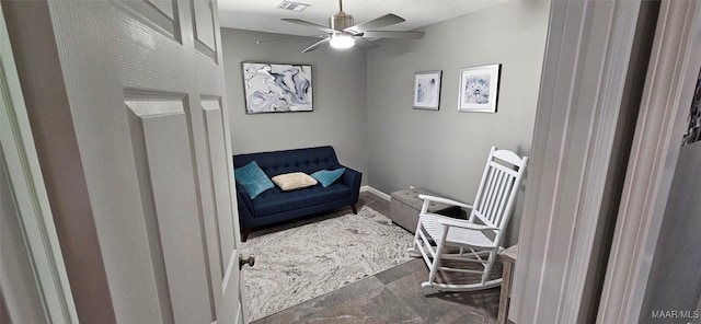 living area featuring ceiling fan