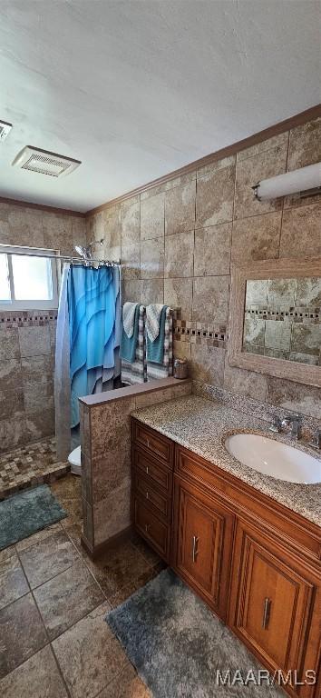 bathroom featuring vanity and a shower with shower curtain