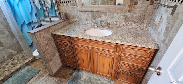 bathroom featuring vanity, tile patterned floors, toilet, and a shower