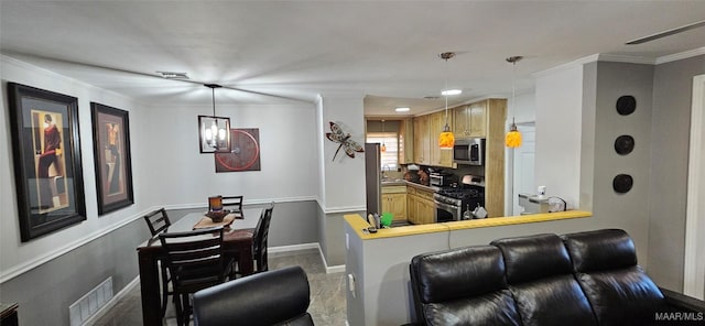 kitchen featuring a breakfast bar, ornamental molding, kitchen peninsula, and appliances with stainless steel finishes