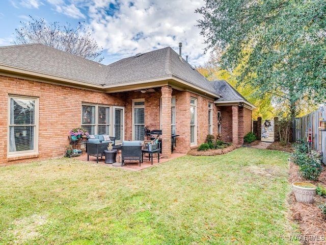 rear view of property with an outdoor living space, a patio, and a yard