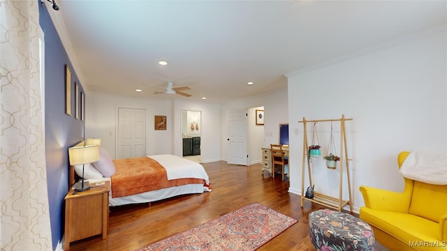 bedroom with dark hardwood / wood-style flooring and ornamental molding