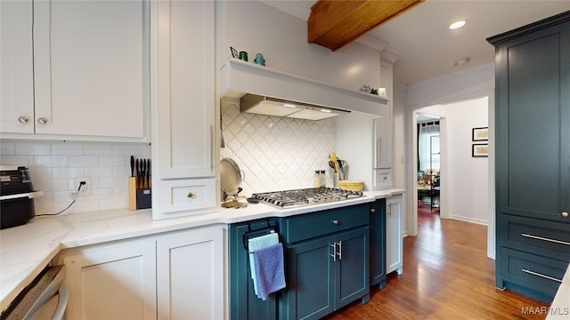 kitchen featuring stainless steel gas stovetop, blue cabinets, dishwashing machine, dark hardwood / wood-style flooring, and light stone countertops