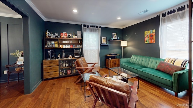 living room featuring hardwood / wood-style flooring and ornamental molding