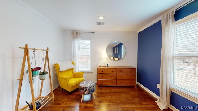 living area with ornamental molding and dark hardwood / wood-style flooring