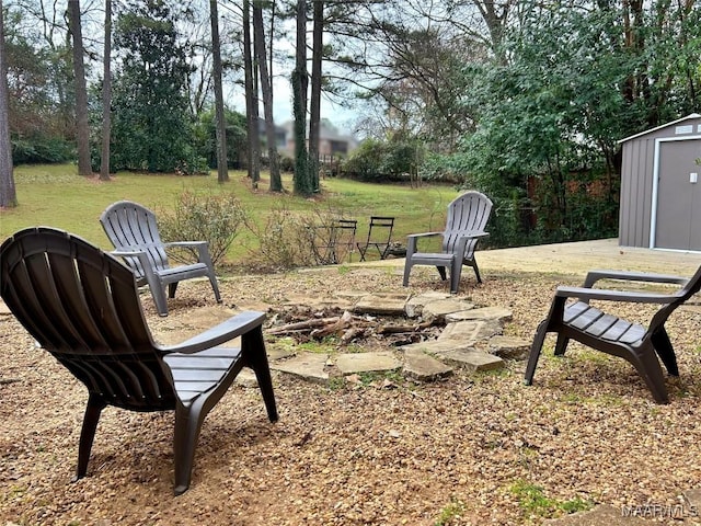 view of yard with a shed and a fire pit