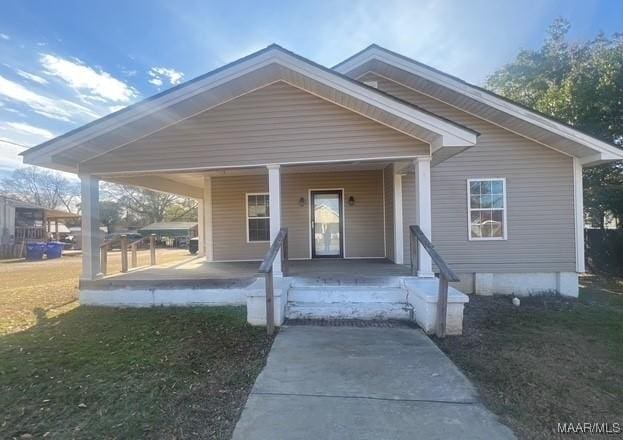 bungalow with a porch and a front yard