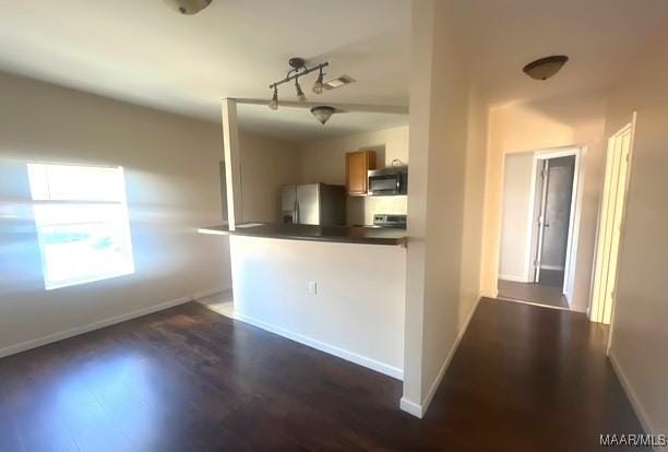 kitchen featuring dark hardwood / wood-style flooring and stainless steel appliances