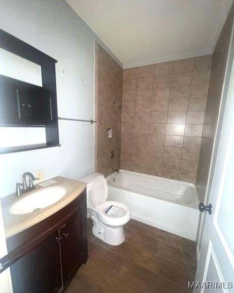 full bathroom with hardwood / wood-style flooring, vanity, toilet, and tiled shower / bath combo