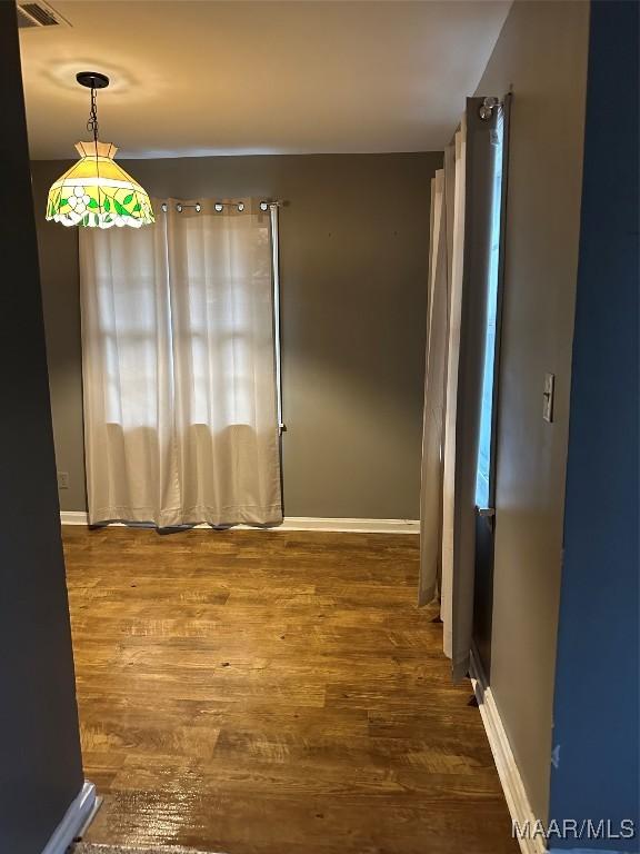 unfurnished room featuring wood-type flooring