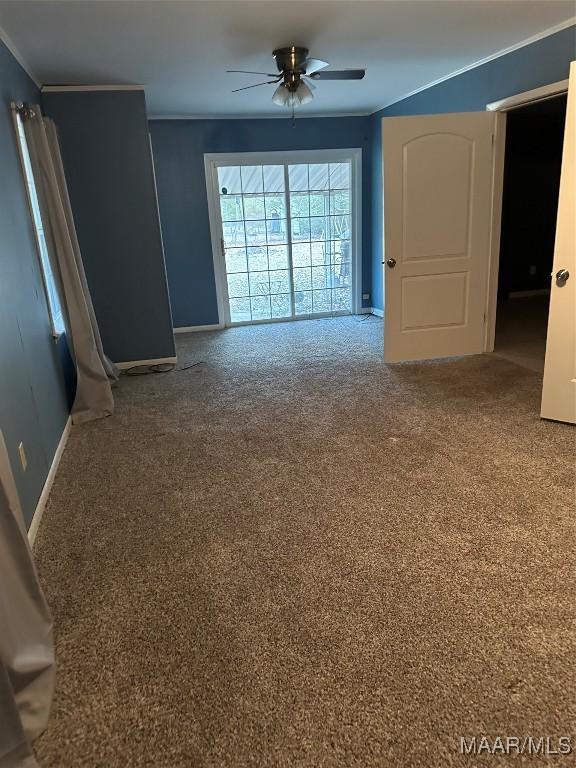 carpeted empty room featuring ornamental molding and ceiling fan