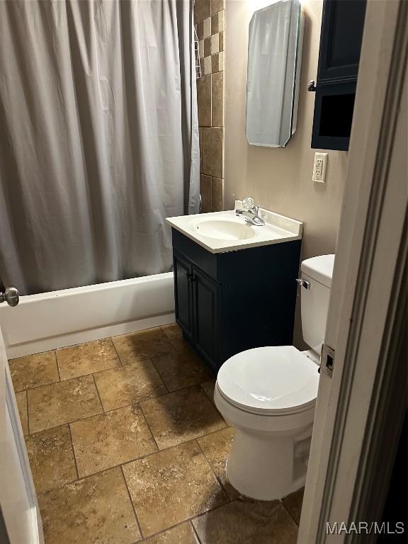 full bathroom with vanity, shower / bath combination with curtain, and toilet