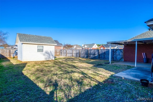 view of yard featuring a shed and a patio area