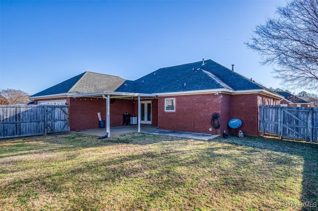 back of house featuring a patio and a lawn