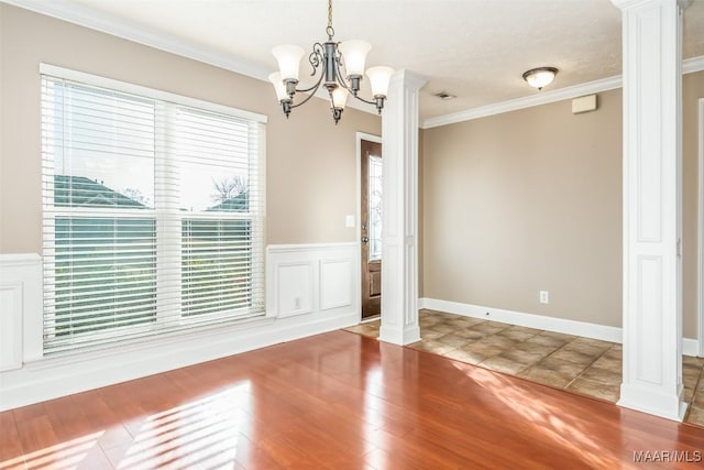 interior space featuring crown molding, decorative columns, and hardwood / wood-style floors