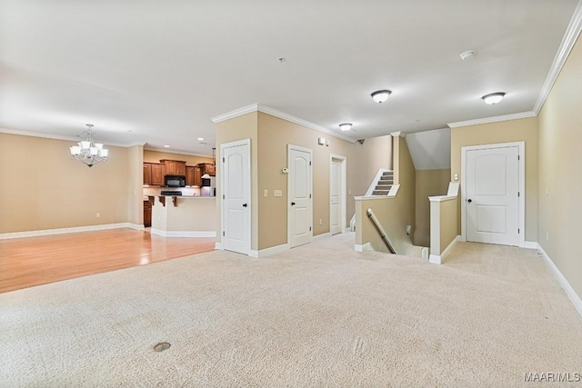 unfurnished room with an inviting chandelier, light colored carpet, and ornamental molding