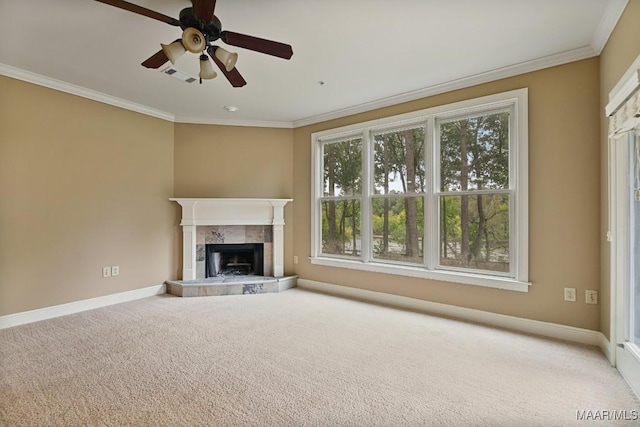 unfurnished living room featuring crown molding, ceiling fan, a fireplace, and carpet floors