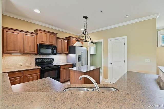 kitchen featuring a center island, sink, decorative backsplash, and black appliances