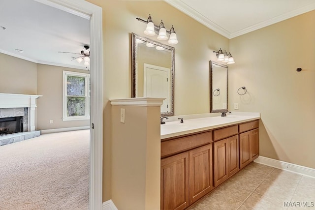 bathroom featuring ornamental molding, vanity, ceiling fan, a high end fireplace, and tile patterned floors