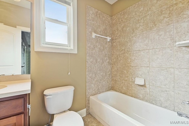 full bathroom featuring vanity, tiled shower / bath, tile patterned flooring, and toilet