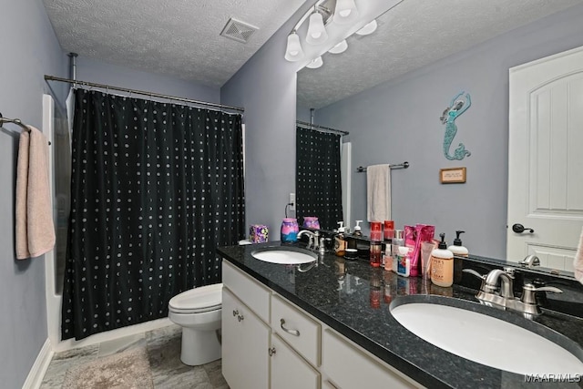 full bathroom featuring vanity, toilet, a textured ceiling, and shower / tub combo with curtain