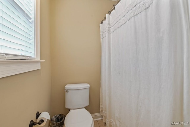 bathroom featuring tile patterned flooring and toilet