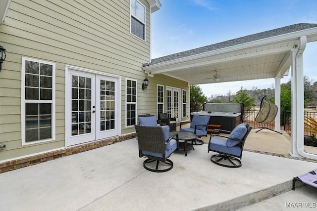 view of patio with a hot tub and french doors