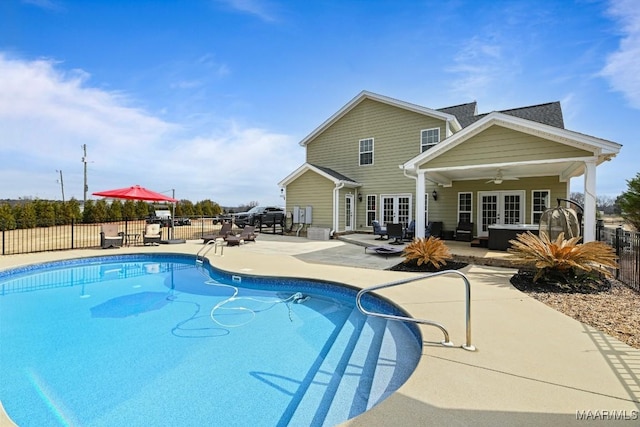 view of swimming pool with a patio area, french doors, and ceiling fan