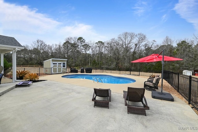 view of swimming pool featuring a storage shed and a patio