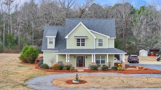 view of front of house with a garage, an outdoor structure, and covered porch