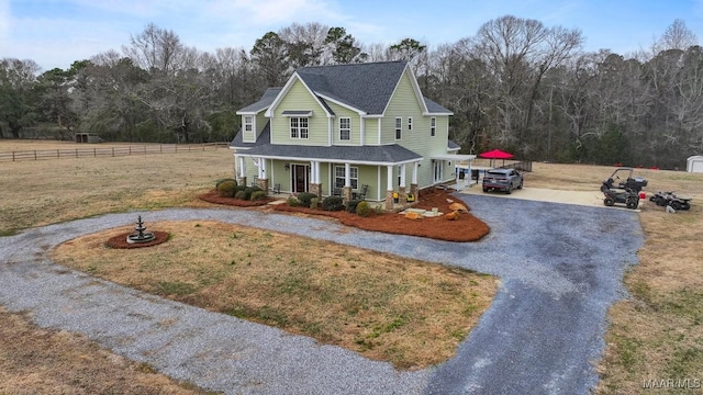 view of front of home with covered porch and a front lawn