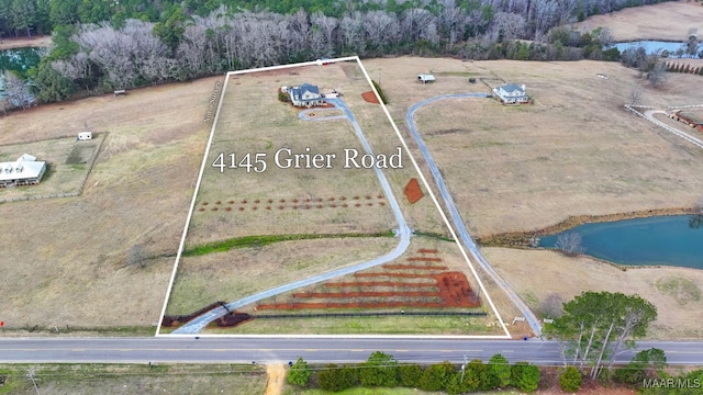 birds eye view of property with a rural view and a water view