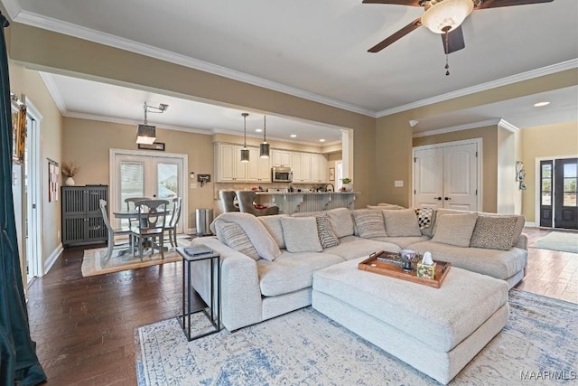 living room with ornamental molding, hardwood / wood-style floors, ceiling fan, and french doors