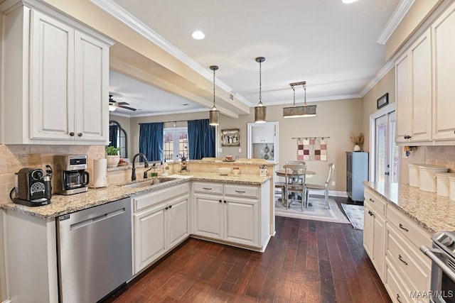 kitchen featuring sink, dishwasher, kitchen peninsula, pendant lighting, and white cabinets