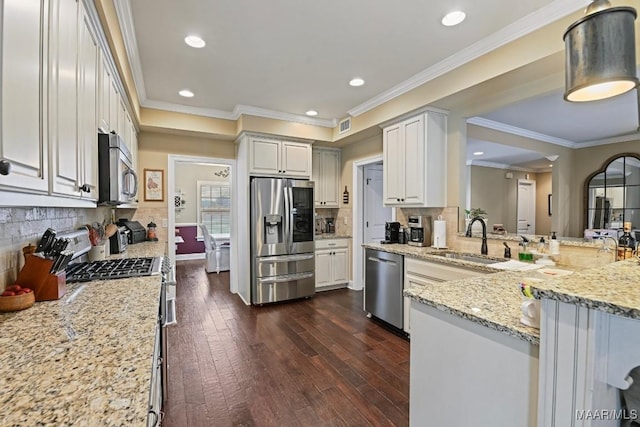 kitchen featuring appliances with stainless steel finishes, dark hardwood / wood-style floors, white cabinetry, sink, and light stone countertops