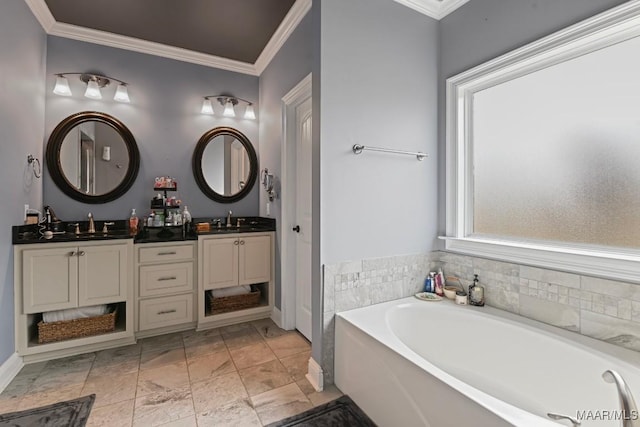 bathroom with ornamental molding, vanity, and a washtub