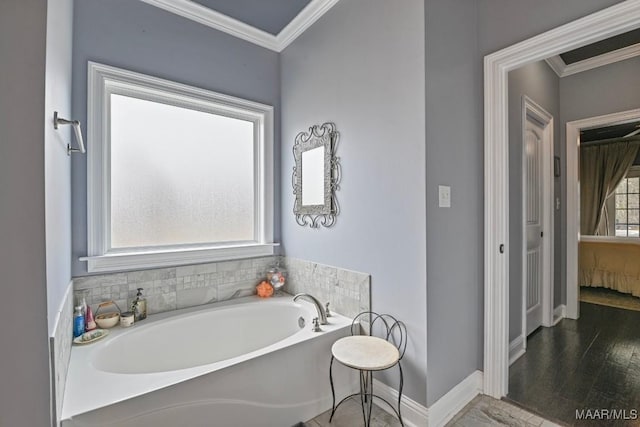 bathroom featuring crown molding, a bathing tub, and hardwood / wood-style flooring