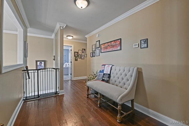 sitting room featuring ornamental molding and dark hardwood / wood-style floors