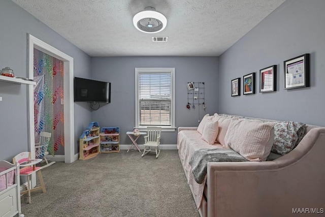 carpeted living room featuring a textured ceiling