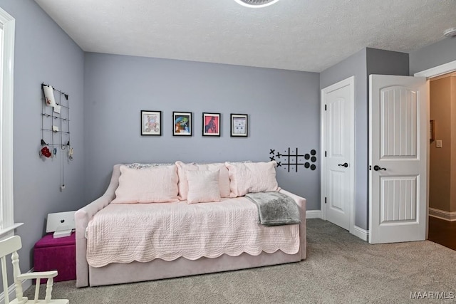 carpeted bedroom featuring a textured ceiling